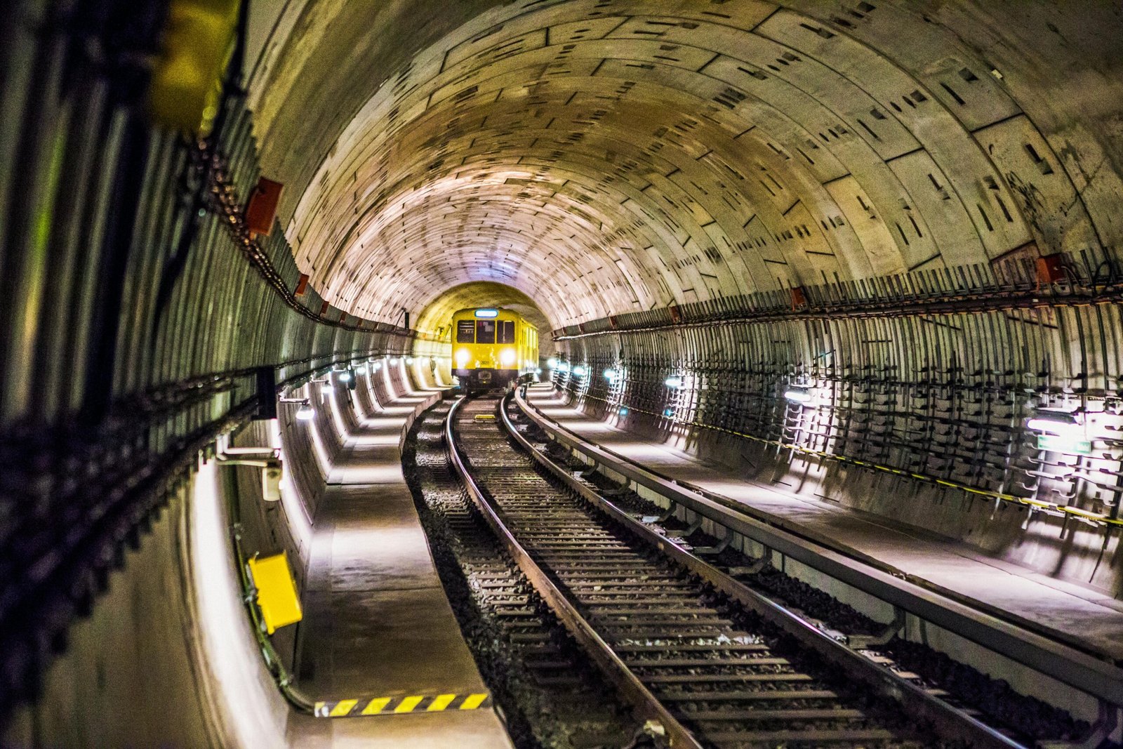 Dramatic view of a Berlin subway tunnel with train approaching, showcasing modern infrastructure.