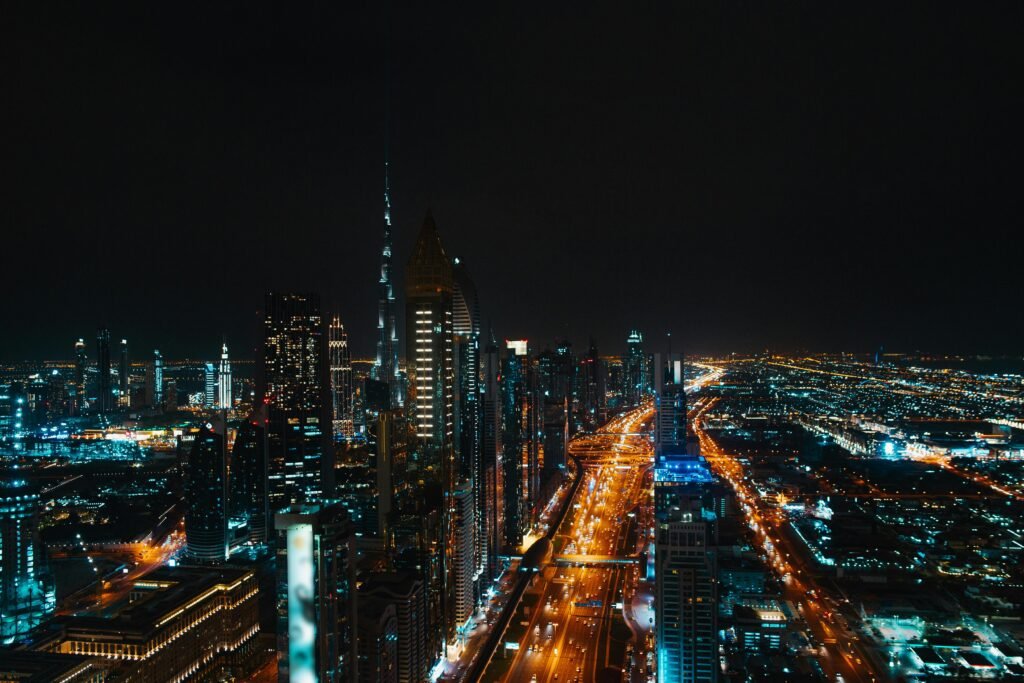 Stunning aerial view of Berlin's skyline at night, featuring illuminated skyscrapers and bustling highways.